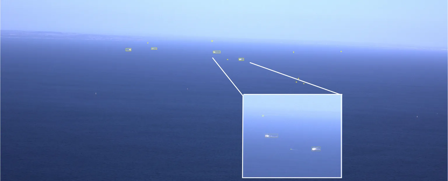 Recorded aerial view of vessels on the water with detection annotations and an enlarged detail.